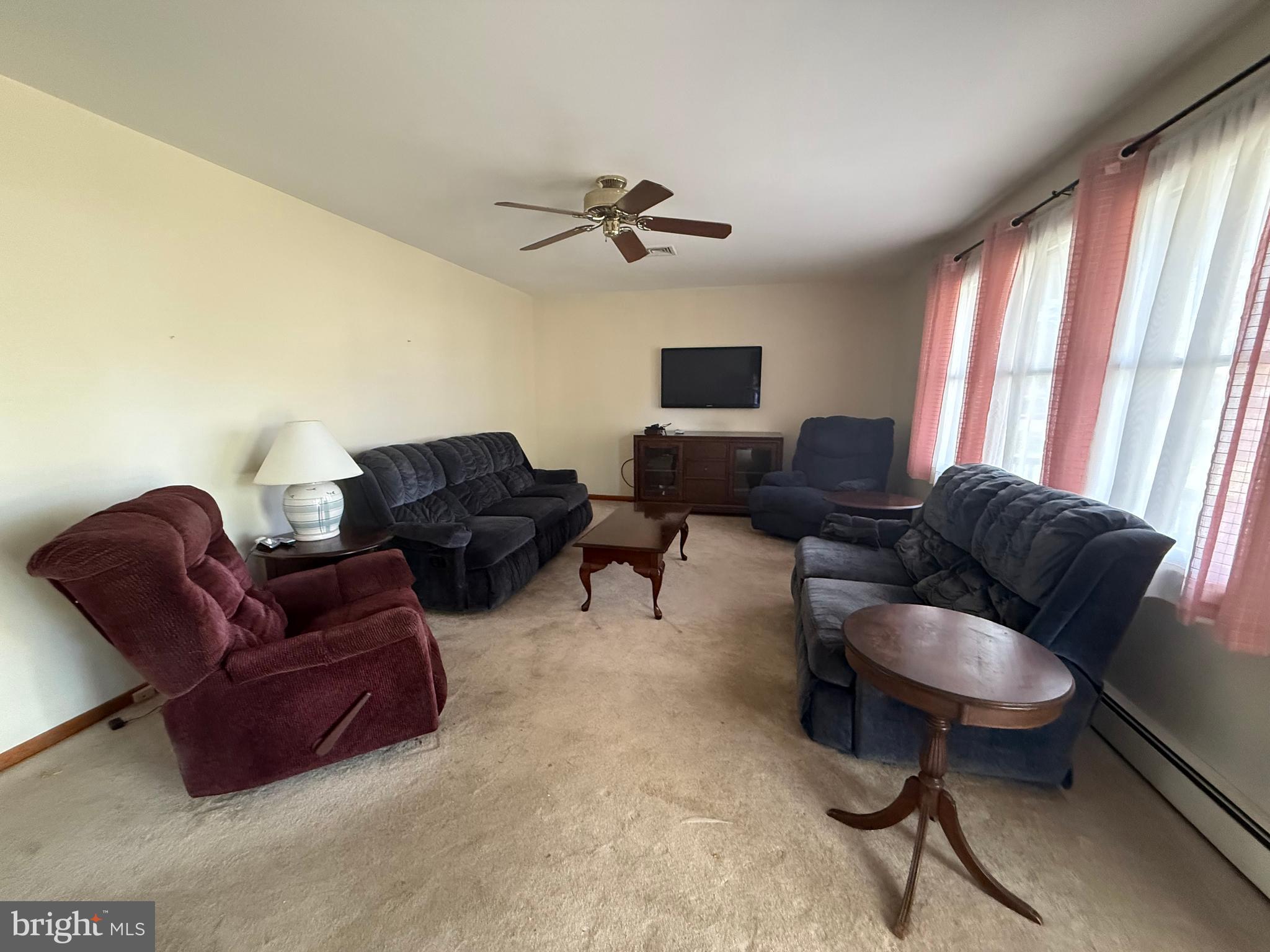 405 Parvin Mill Road Bridgeton, NJ 08302 - Photo 8 of 28 a living room with furniture a ceiling fan and a window