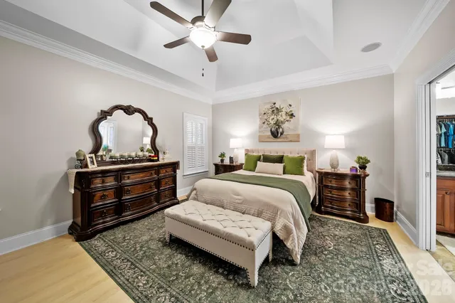 a bedroom with a bed and a chandelier