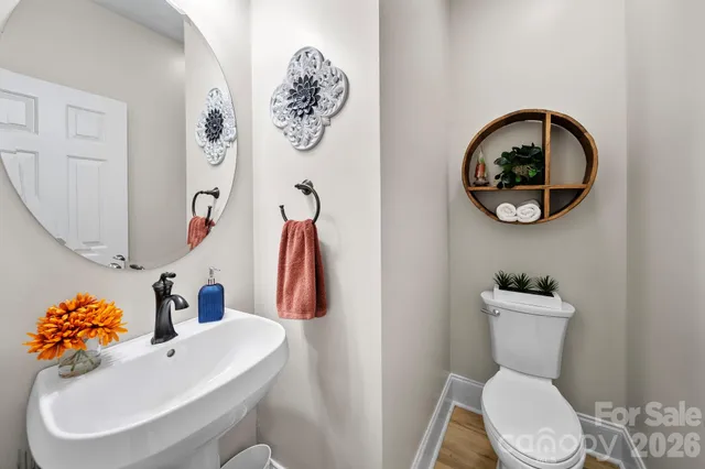 a bathroom with a toilet a sink and a mirror