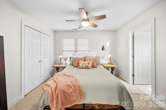 a bed room with a bed and a ceiling fan