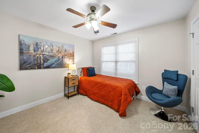 a bed room with a bed and a chair