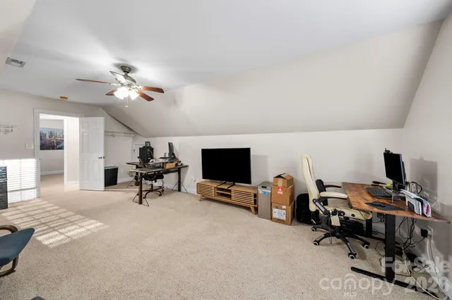 a view of a livingroom with workspace and a couch