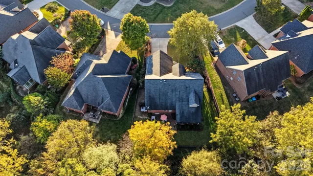 an aerial view of a house with a yard and garden