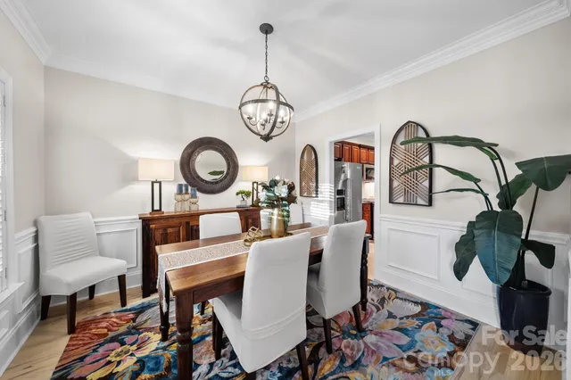 a view of a dining room with furniture wooden floor and a rug