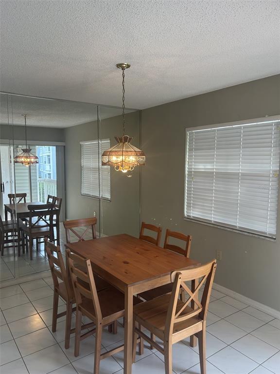 6932 Stonesthrow Circle North, Unit 7204 St. Petersburg, FL 33710 - Photo 13 of 27 a view of a dining room with furniture and window