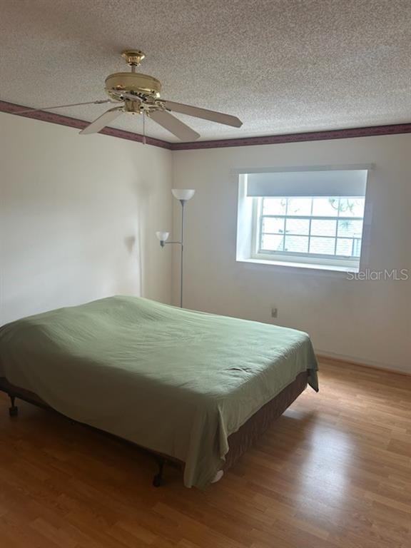 6932 Stonesthrow Circle North, Unit 7204 St. Petersburg, FL 33710 - Photo 15 of 27 a bed sitting in a bedroom next to a window