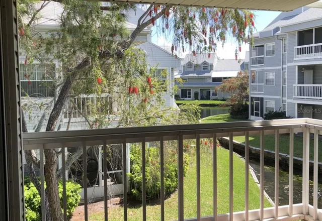 a view of a swimming pool with a patio and a yard