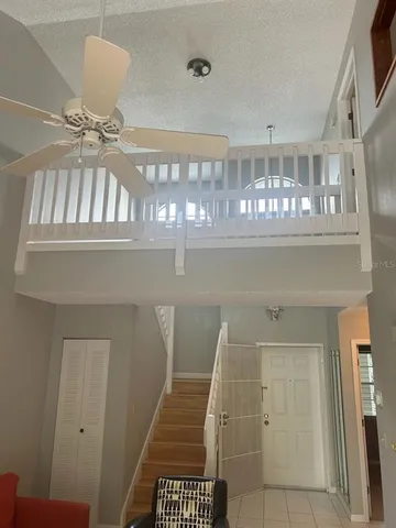 a living room with furniture and floor to ceiling window