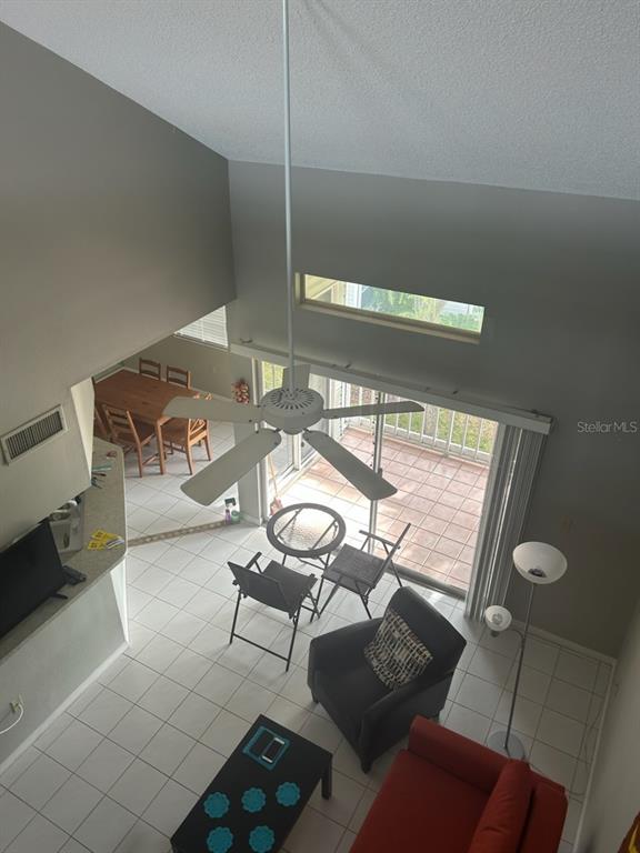 6932 Stonesthrow Circle North, Unit 7204 St. Petersburg, FL 33710 - Photo 10 of 27 a living room with furniture and floor to ceiling window