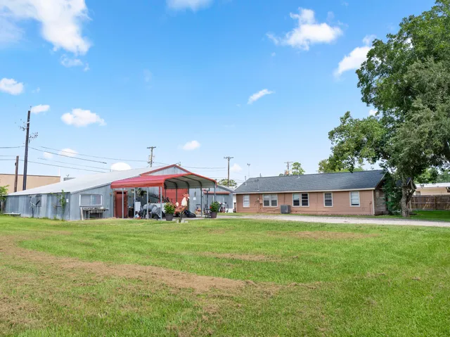 a view of a house with a yard and sitting area
