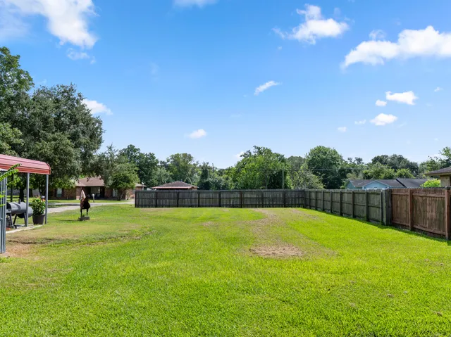 a swimming pool with outdoor seating and yard