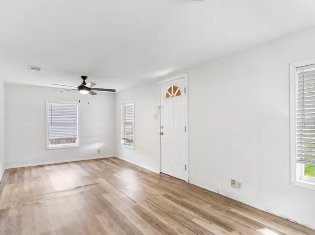 wooden floor in an empty room with a window
