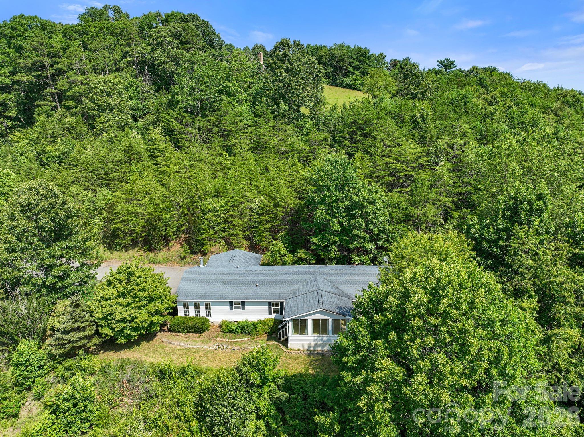 133 Spivey Mountain Road Asheville, NC 28806 - Photo 39 of 40 an aerial view of a house with yard and outdoor seating