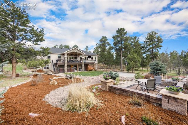 11628 Shaugnessy Road Colorado Springs, CO 80908 - Photo 42 of 50 Rear view of property featuring a wooden deck and a patio