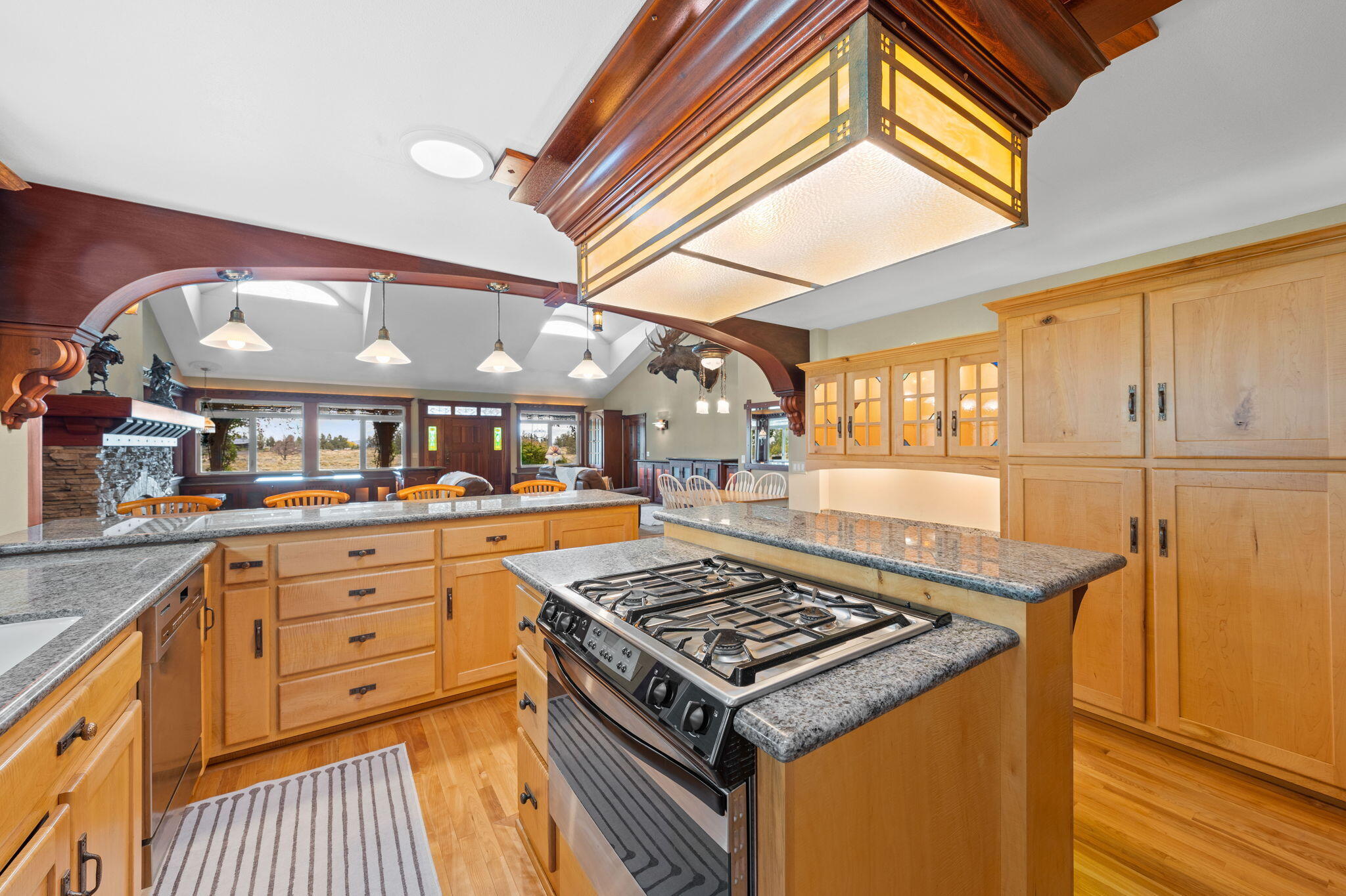 21925 Bear Creek Road Bend, OR 97702 - Photo 23 of 104 a kitchen with stainless steel appliances granite countertop a stove and a sink