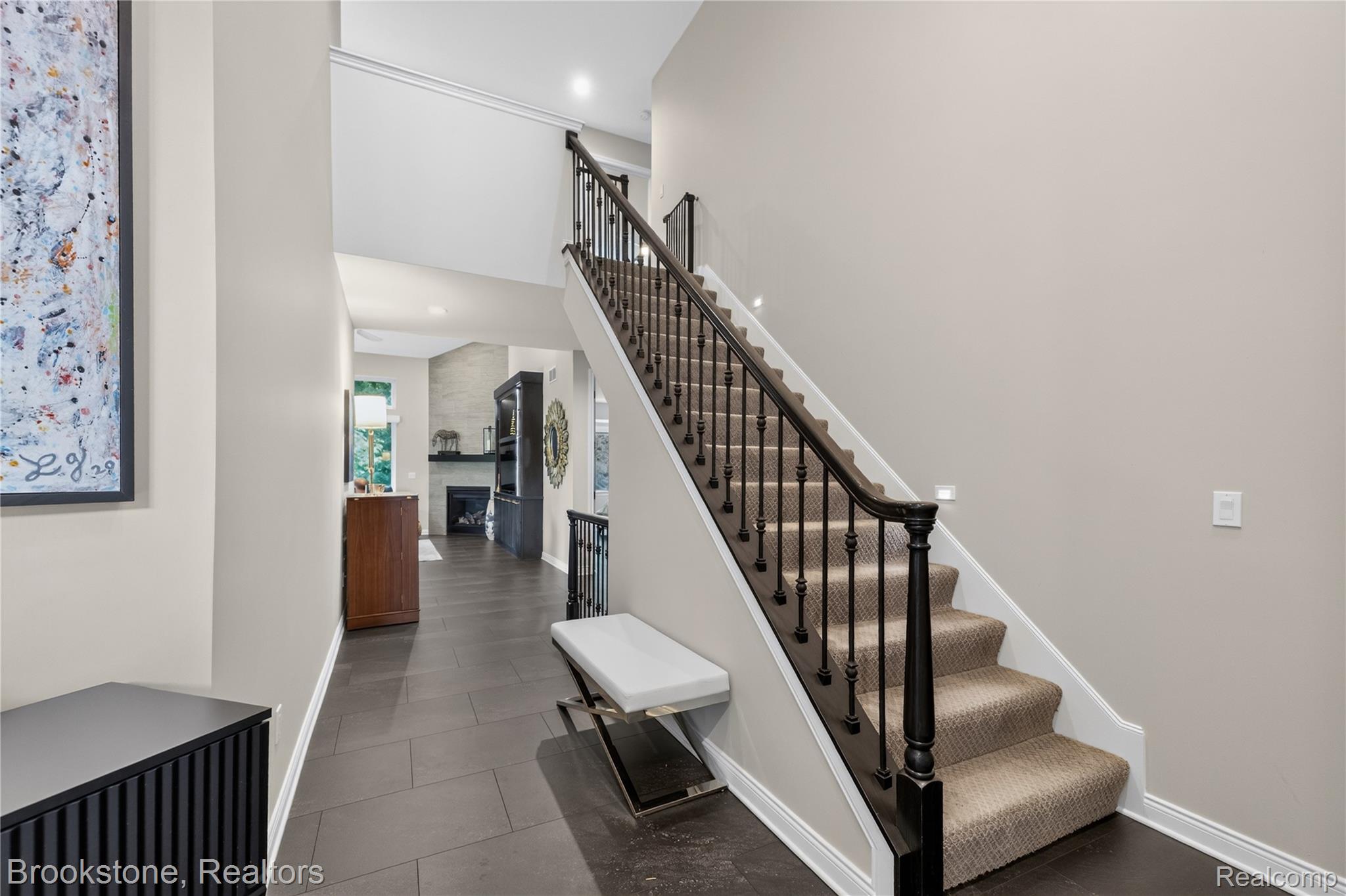 2167 Sanctuary Court Rochester, MI 48309 - Photo 19 of 68 Two-story foyer featuring dark wood-finish flooring, a carpeted staircase with a dark wood handrail and balusters, recessed lighting, and white baseboards