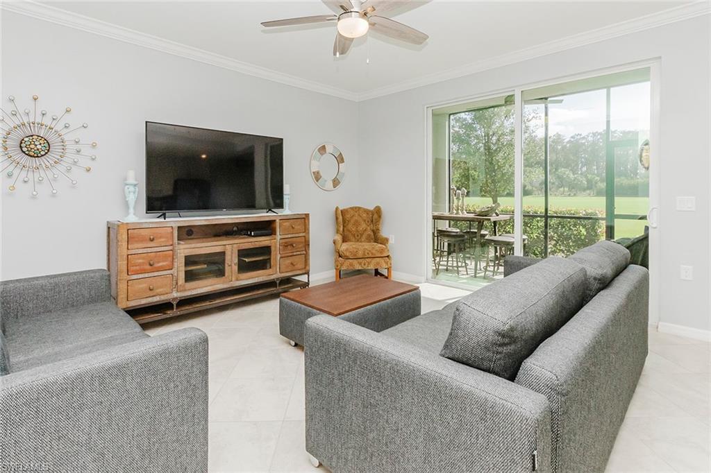 6082 National Blvd Avenue, Unit 115 Immokalee, FL 34142 - Photo 12 of 50 a living room with furniture and a flat screen tv