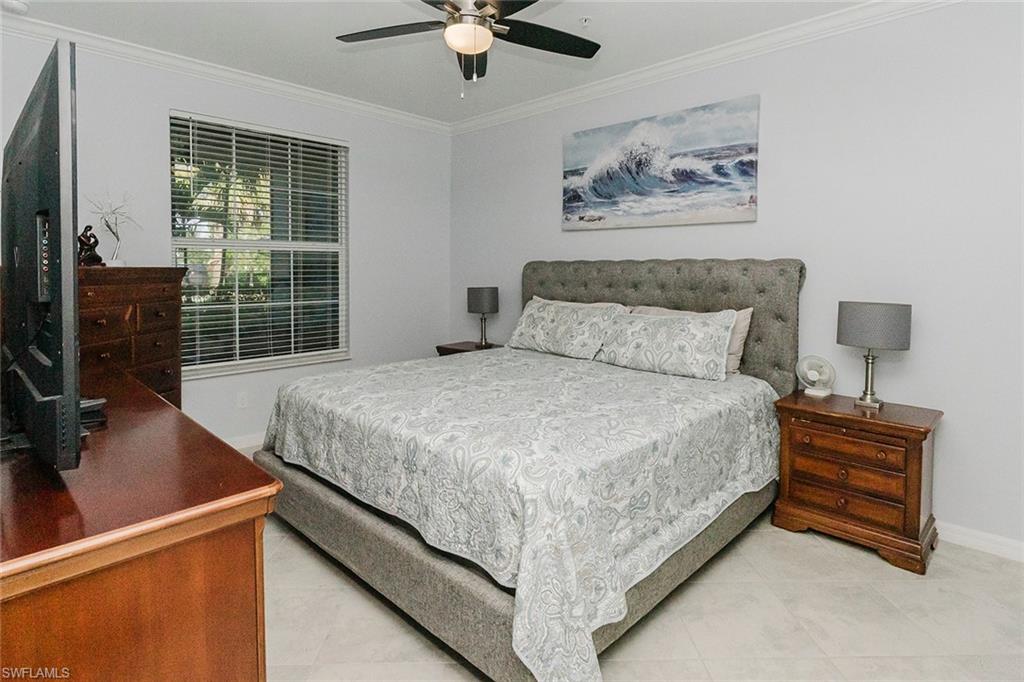6082 National Blvd Avenue, Unit 115 Immokalee, FL 34142 - Photo 16 of 50 a bedroom with a bed dresser and a window