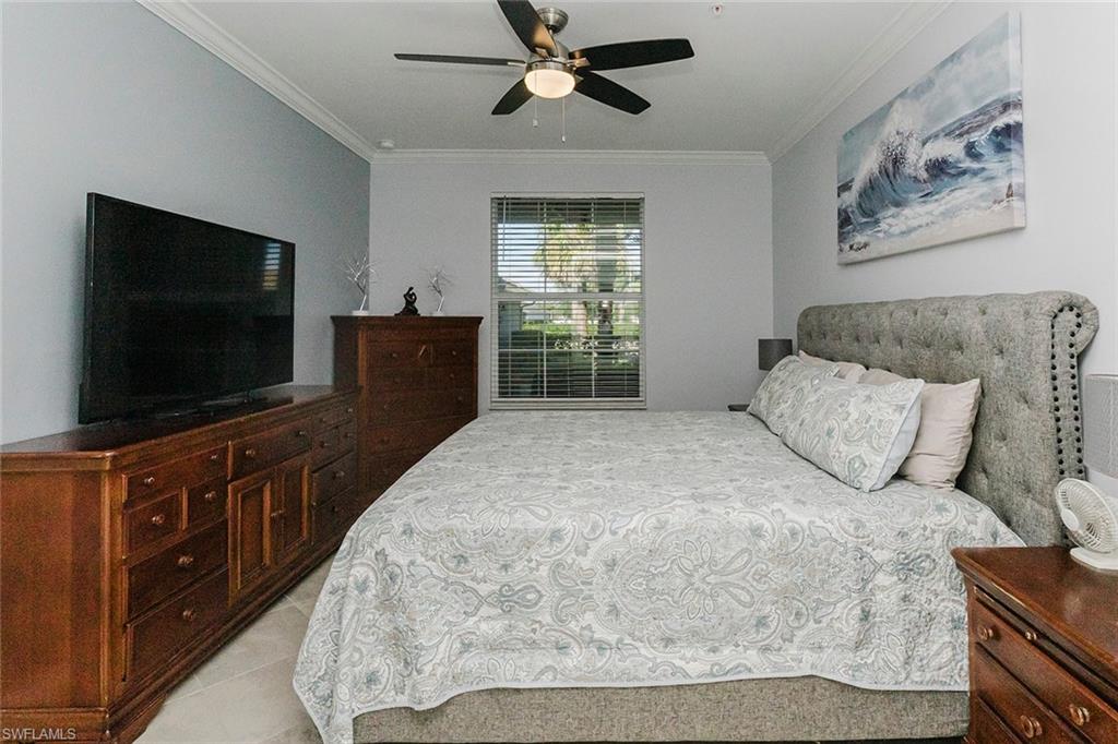 6082 National Blvd Avenue, Unit 115 Immokalee, FL 34142 - Photo 17 of 50 a bedroom with a large bed and a flat screen tv