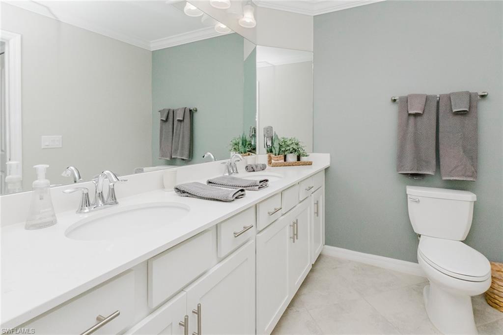 6082 National Blvd Avenue, Unit 115 Immokalee, FL 34142 - Photo 19 of 50 a bathroom with double sink and a toilet