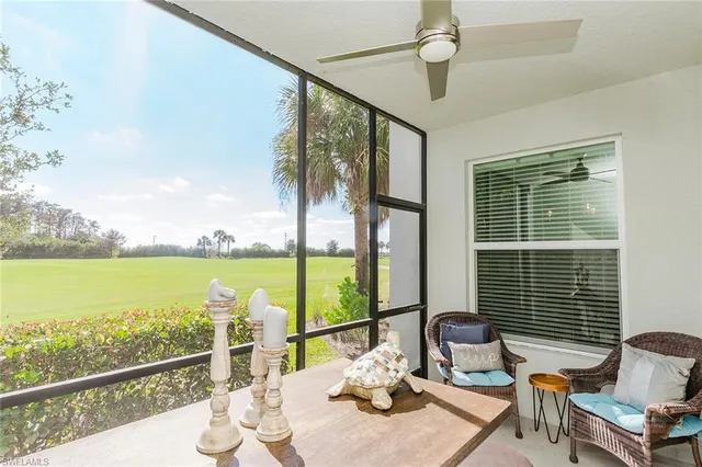 a front view of a house with a yard and potted plants