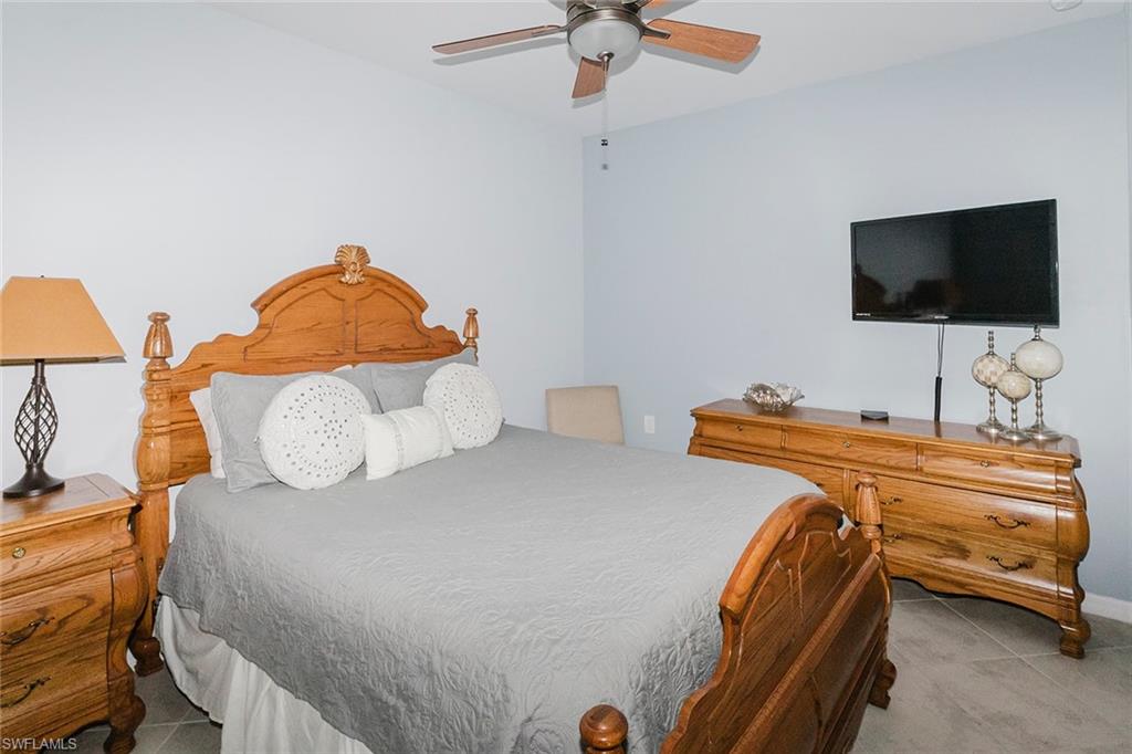 6082 National Blvd Avenue, Unit 115 Immokalee, FL 34142 - Photo 21 of 50 a bedroom with a bed and a flat screen tv