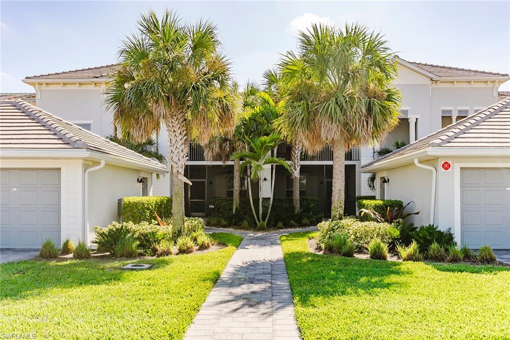 6082 National Blvd Avenue, Unit 115 Immokalee, FL 34142 - Photo 3 of 50 a front view of house and yard with green space
