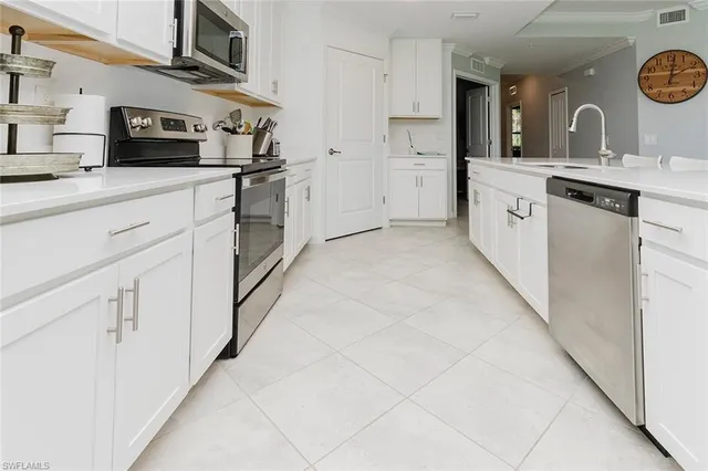 a living room with furniture a clock and a wooden floor