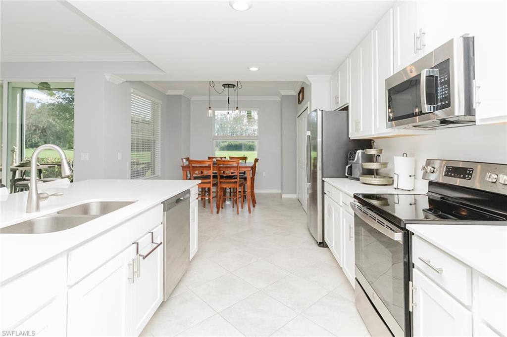 6082 National Blvd Avenue, Unit 115 Immokalee, FL 34142 - Photo 8 of 50 a kitchen with stainless steel appliances a stove sink microwave and cabinets