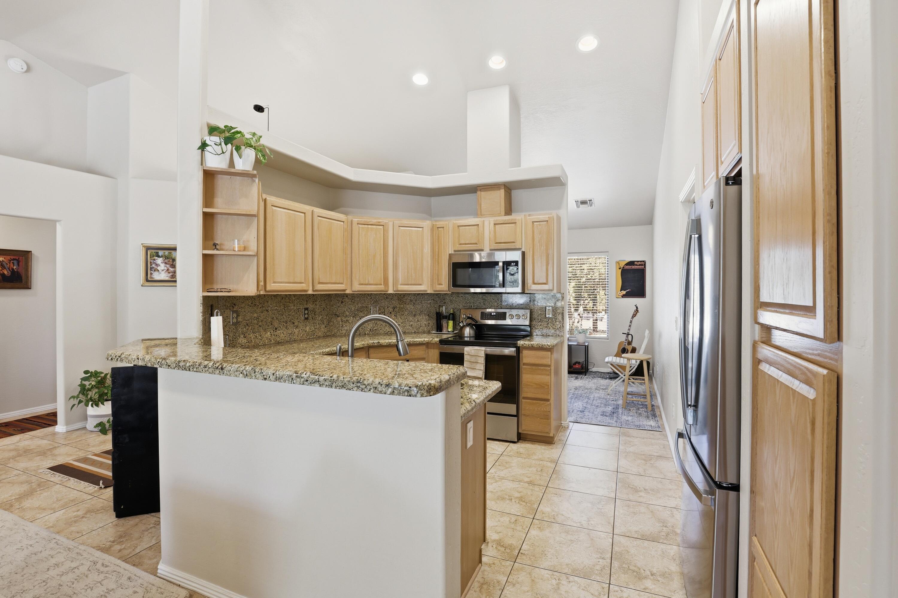 910 West Wagon Trail Payson, AZ 85541 - Photo 9 of 35 a kitchen with stainless steel appliances granite countertop a refrigerator and a stove top oven
