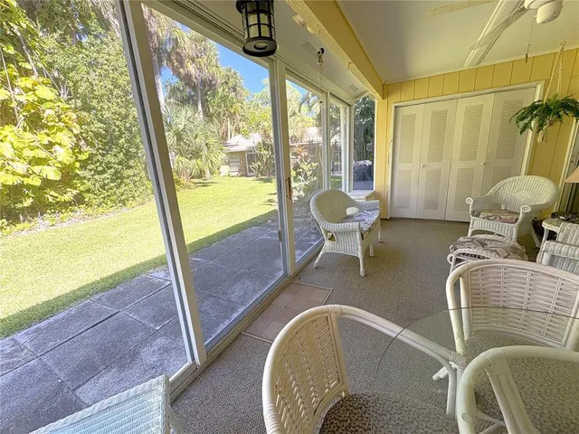 a room with furniture and a floor to ceiling window
