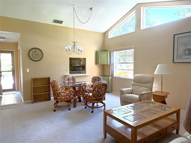 a living room with furniture a fireplace and a window
