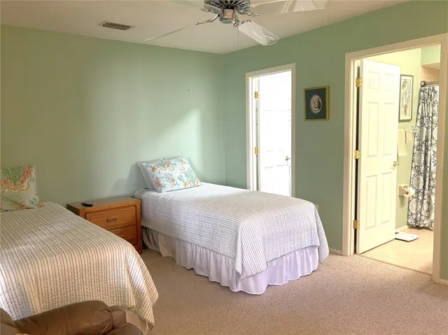 a bedroom with two beds and painted walls