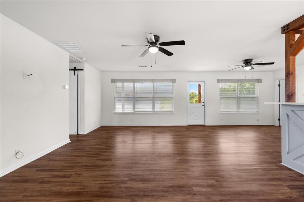 13132 Highway 78 Blue Ridge, TX 75424 - Photo 8 of 35 Spacious room featuring wood-finish flooring, white walls, and multiple windows with blinds