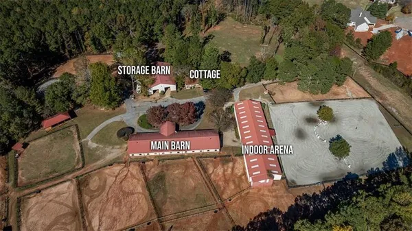 an aerial view of a house with a yard and trees