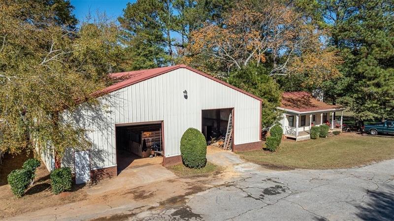 3055 A Spring Hill Drive Monroe, GA 30656 - Photo 33 of 65 a view of a white house with a yard