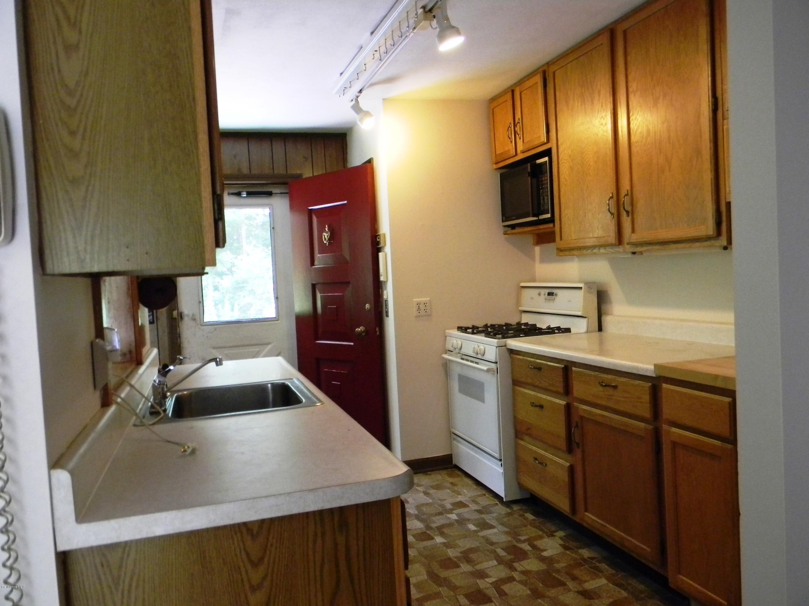 59 Oak Road Richmond, MA 01201 - Photo 3 of 11 a kitchen with stainless steel appliances a sink stove and refrigerator