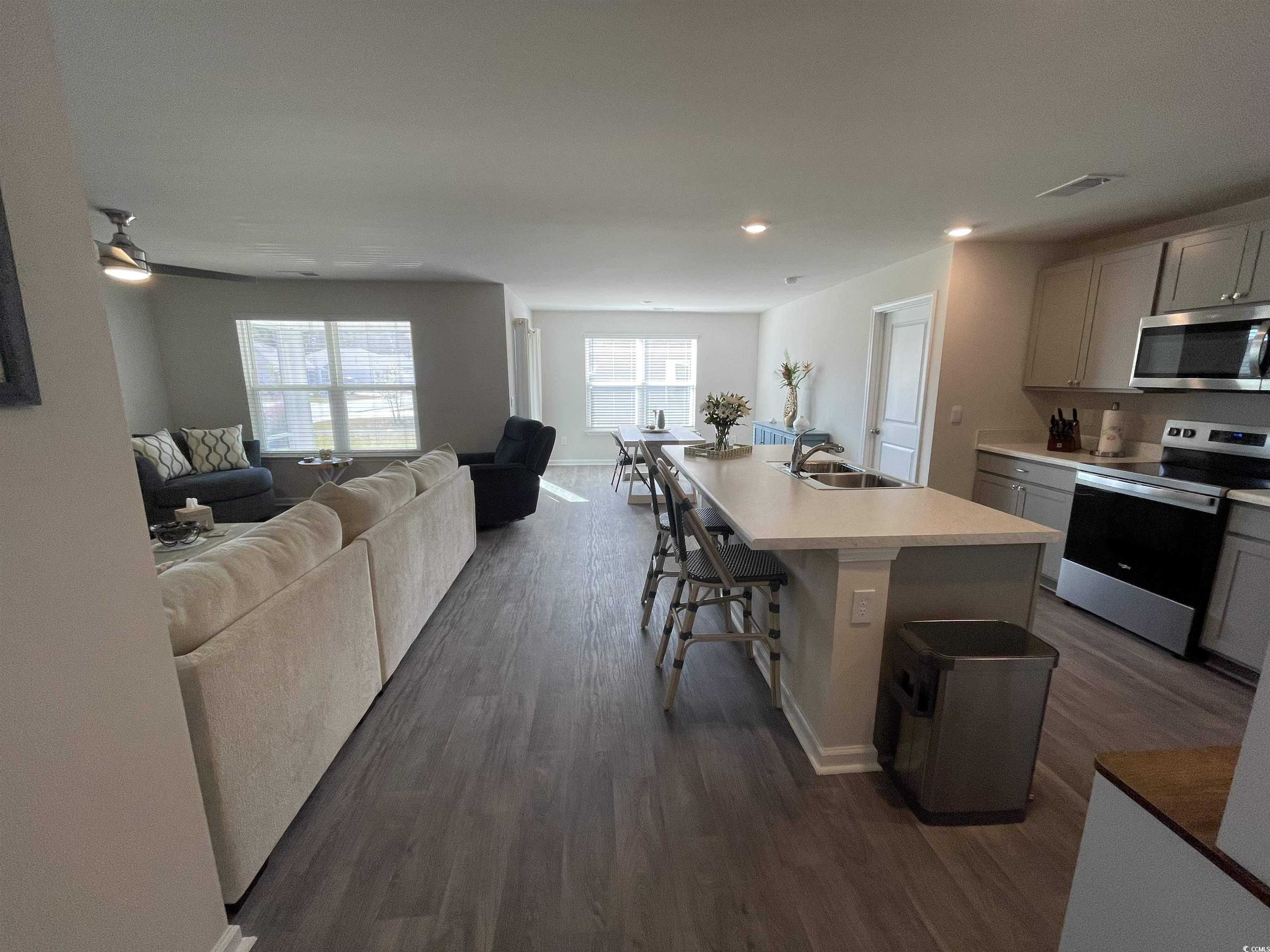 351 Jeff Waters Circle Longs, SC 29568 - Photo 33 of 33 Kitchen with stainless steel appliances, open floor plan, dark wood-style floors, light countertops, and recessed lighting
