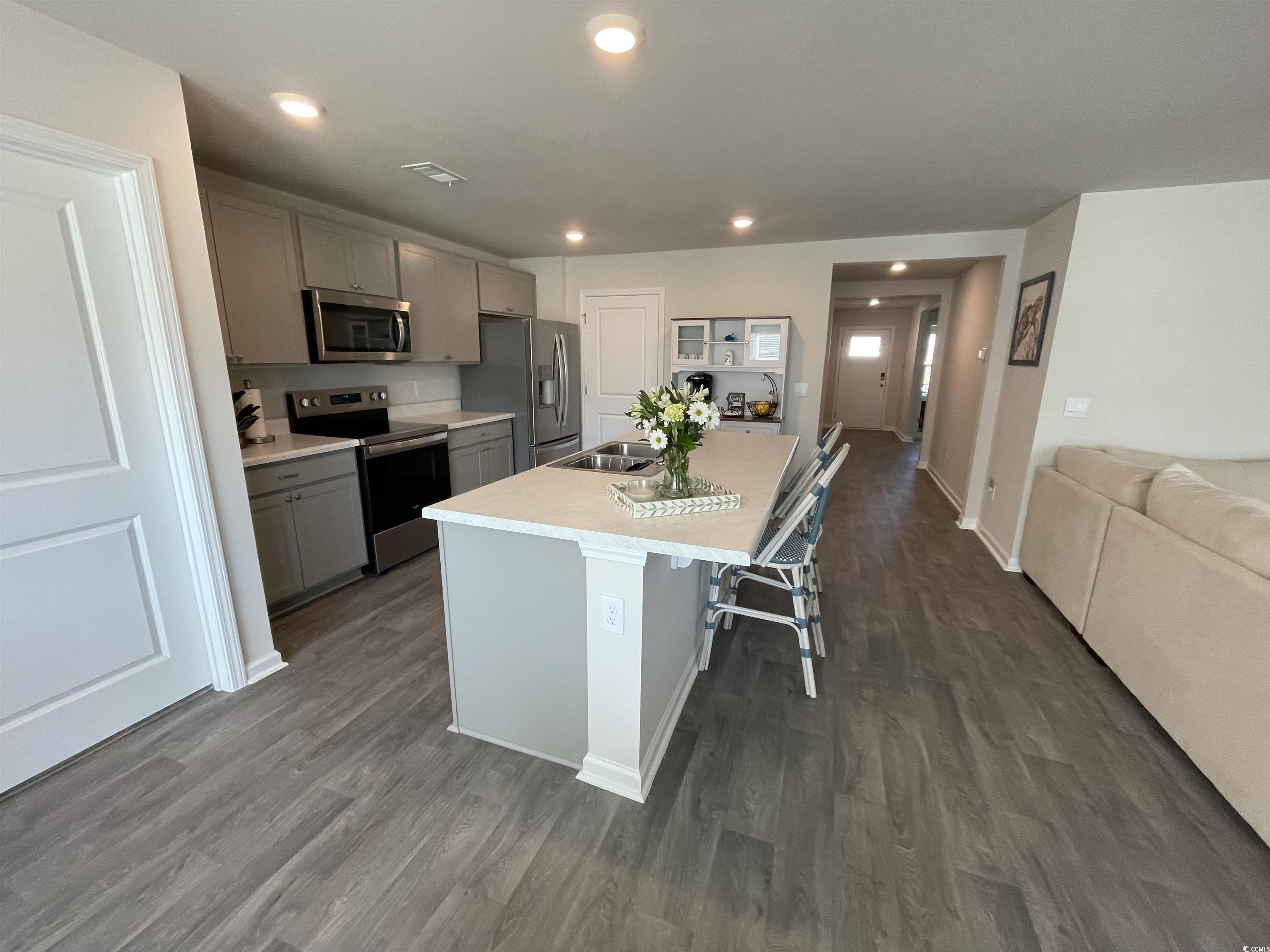 351 Jeff Waters Circle Longs, SC 29568 - Photo 13 of 33 Kitchen with appliances with stainless steel finishes, gray cabinets, recessed lighting, a center island with sink, and a kitchen breakfast bar