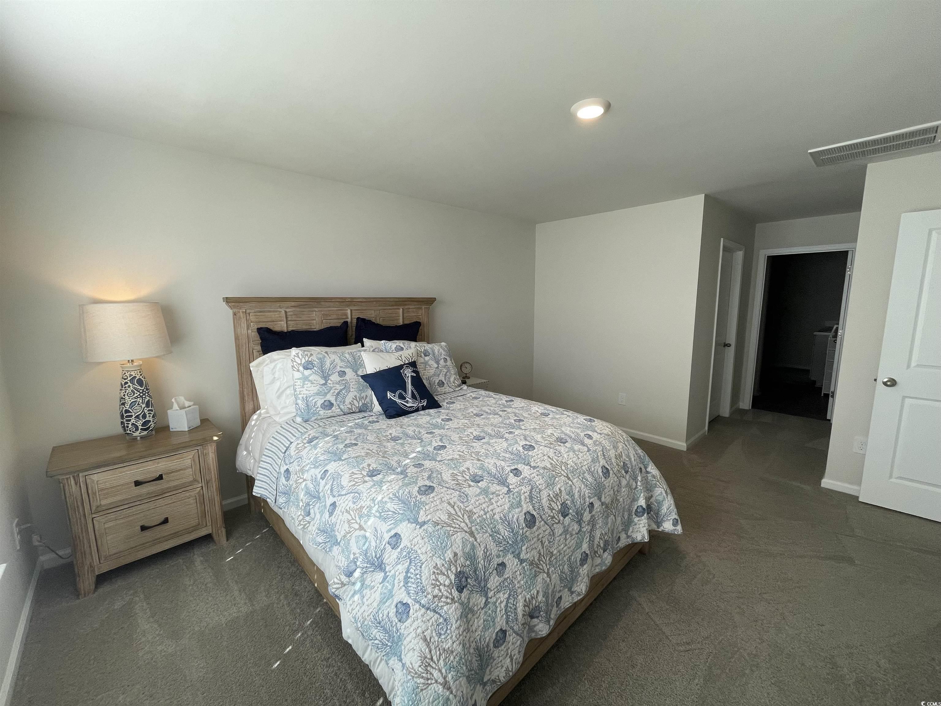 351 Jeff Waters Circle Longs, SC 29568 - Photo 14 of 33 Bedroom with dark carpet and baseboards