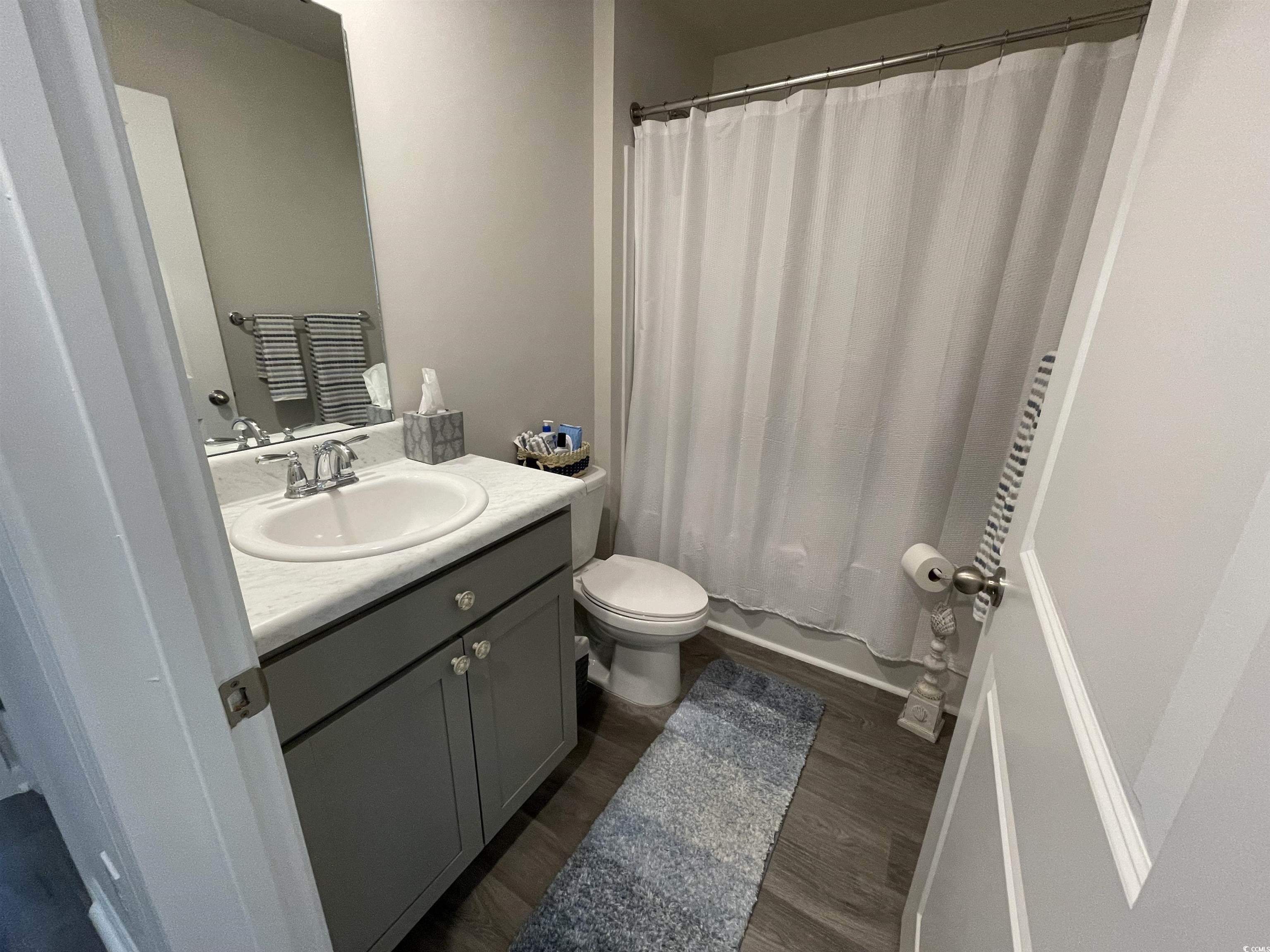 351 Jeff Waters Circle Longs, SC 29568 - Photo 23 of 33 Full bath featuring dark wood finished floors and vanity