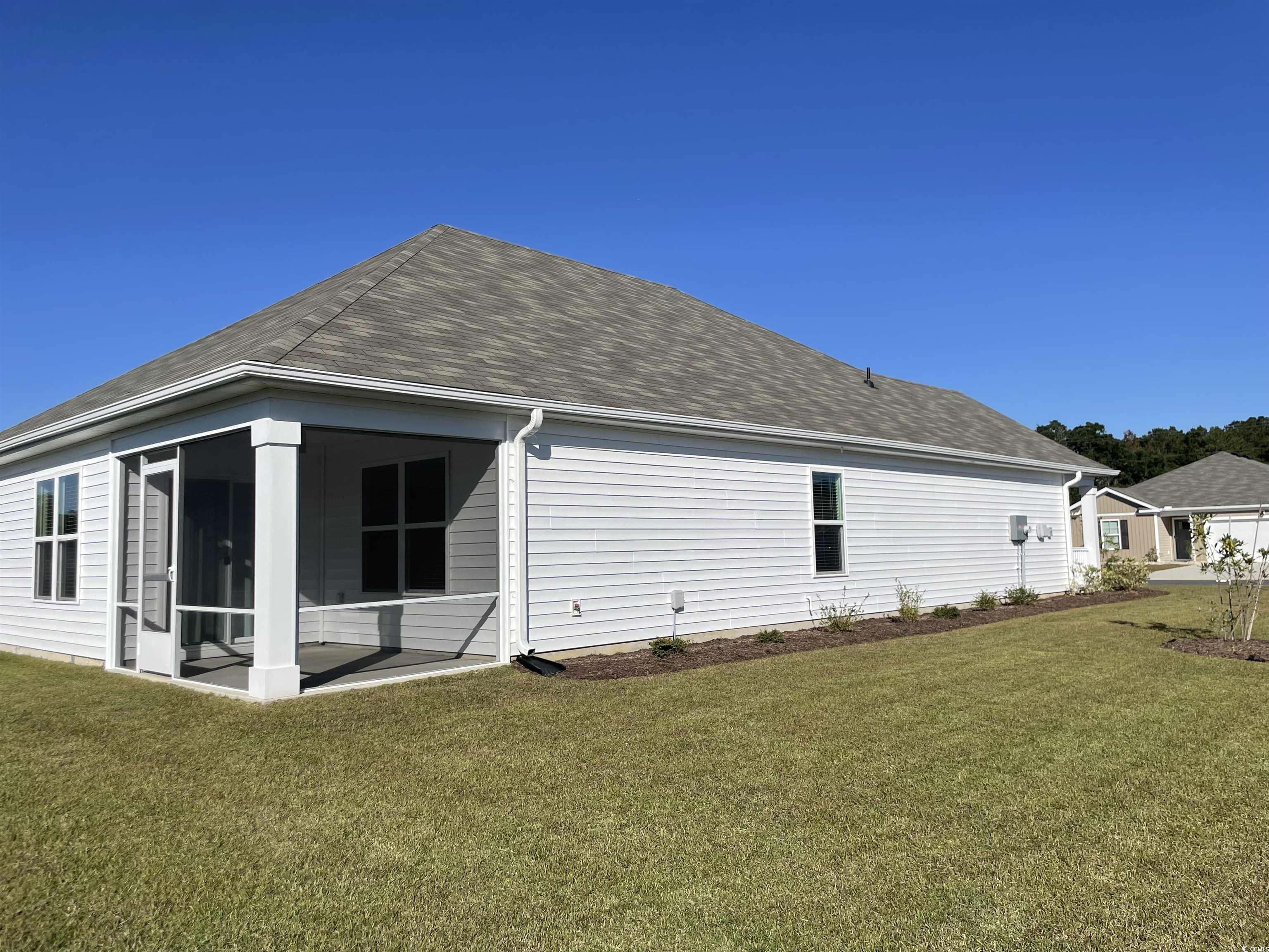 351 Jeff Waters Circle Longs, SC 29568 - Photo 32 of 33 Back of property featuring a lawn, a sunroom, and a shingled roof