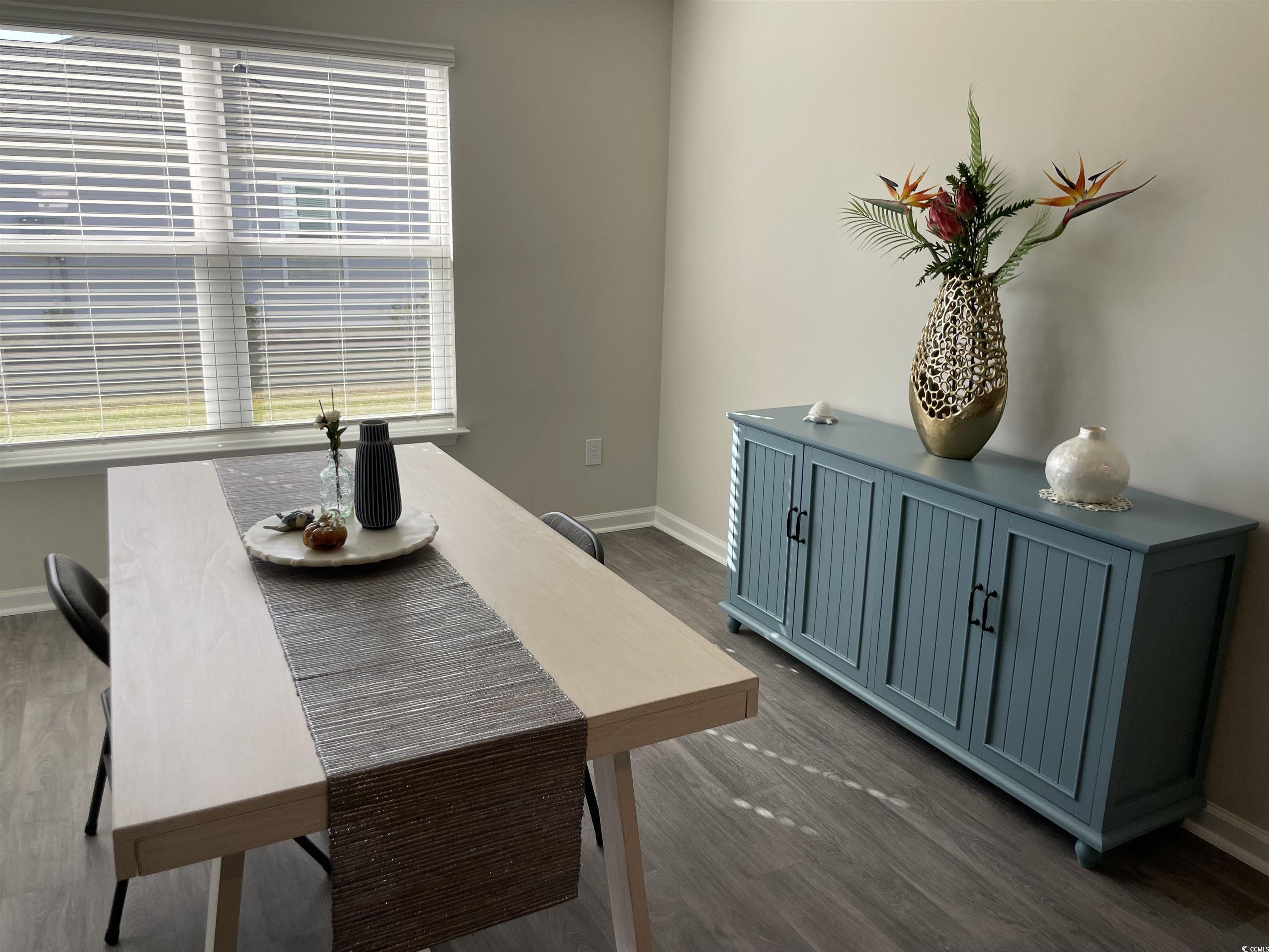 351 Jeff Waters Circle Longs, SC 29568 - Photo 8 of 33 Dining space with dark wood-style floors