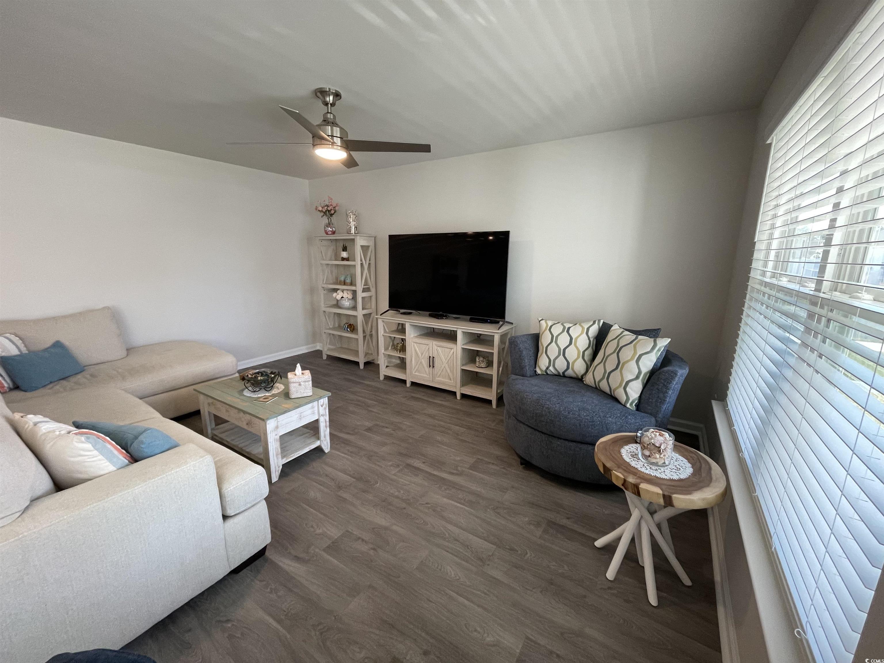 351 Jeff Waters Circle Longs, SC 29568 - Photo 10 of 33 Living area with wood finished floors and a ceiling fan