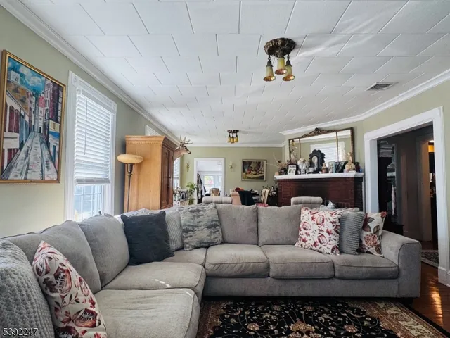 a living room with furniture and a chandelier
