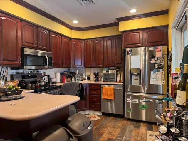 a kitchen with granite countertop a sink appliances and cabinets