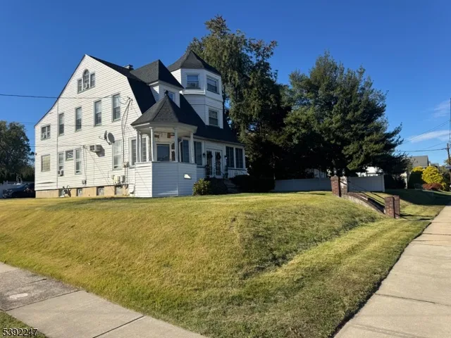 a front view of a building with a garden