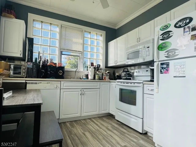 a kitchen with a white cabinets and white appliances