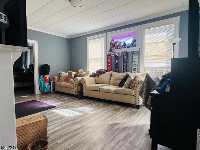 a living room with furniture a fireplace and wooden floor
