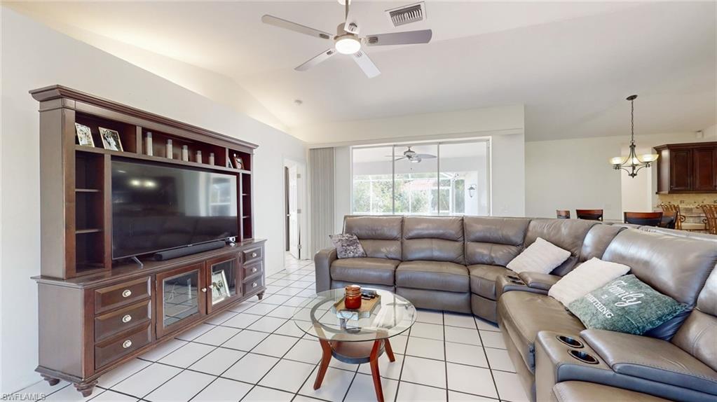 18249 Lee Road Fort Myers, FL 33967 - Photo 4 of 31 a living room with furniture and a flat screen tv